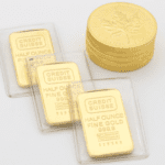 Gold canada maples coins next to gold bars