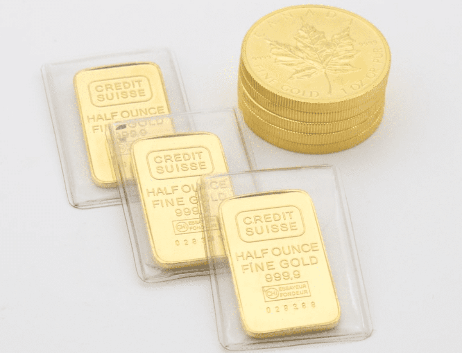 Gold canada maples coins next to gold bars