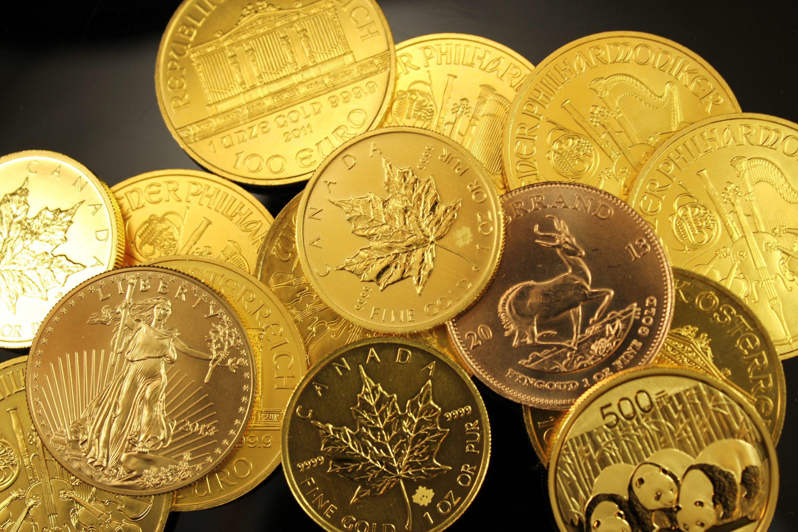 various types of gold coins on black background